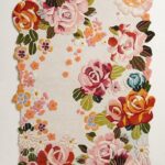 Hand tufted irregular floral rug with vintage roses, daisies, and scalloped border in pink, red, and pastel tones