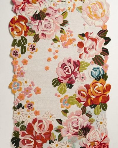 Hand tufted irregular floral rug with vintage roses, daisies, and scalloped border in pink, red, and pastel tones