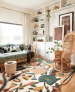 Hand tufted tropical botanical wool rug with jungle flowers, sunbursts, and bold leaves in yellow, red, green, and blue