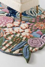 Hand tufted irregular botanical rug with pomegranates, berries, citrus blooms, and floral motifs in multicolor wool