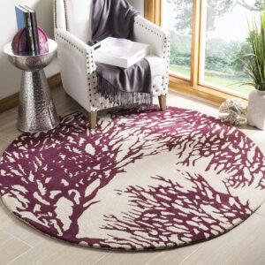 Artistic round rug in maroon and cream abstract pattern