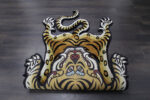 Tiger shaped rug with Tibetan art style and bold black stripes on golden brown wool