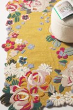 Yellow hand tufted floral rug with multicolored 3D blooming flowers and scalloped edges