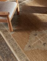 Traditional geometric hand knotted wool rug in earthy tones