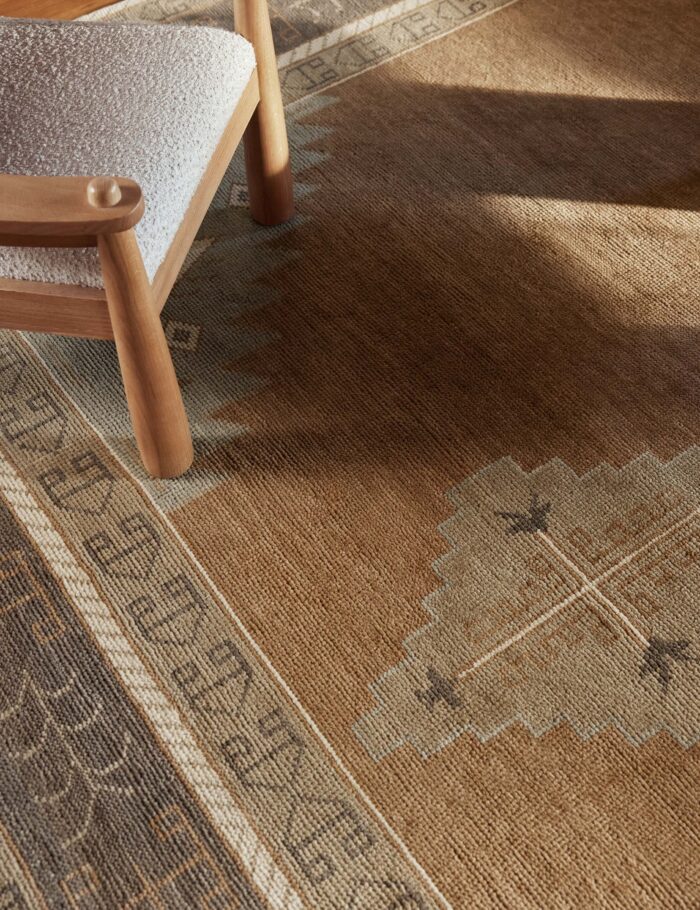 Traditional geometric hand knotted wool rug in earthy tones