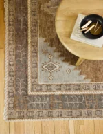 Traditional geometric hand knotted wool rug in earthy tones