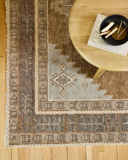 Traditional geometric hand knotted wool rug in earthy tones