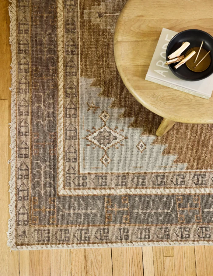 Traditional geometric hand knotted wool rug in earthy tones