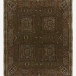 Hand knotted wool rug with tribal geometric pattern in earthy tones